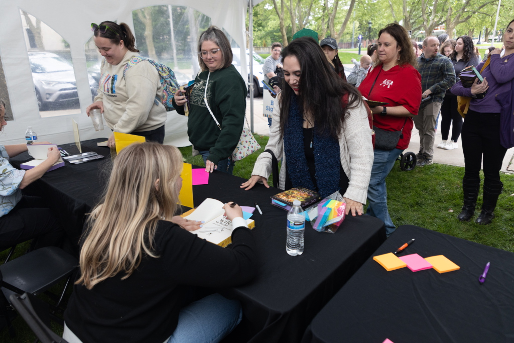 An author signing copies of their book for a line of attendees at Pgh Book Fest 2025 